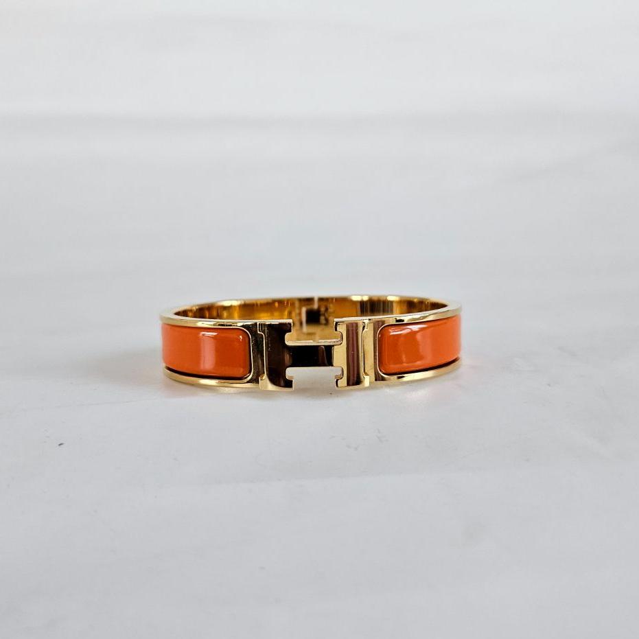 Hermès Clic Clac Gold Bracelet w/ Orange Enamel