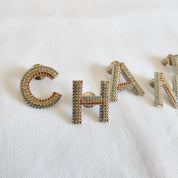 CHANEL crystal embellished Letter brooch