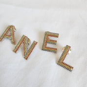 CHANEL crystal embellished Letter brooch