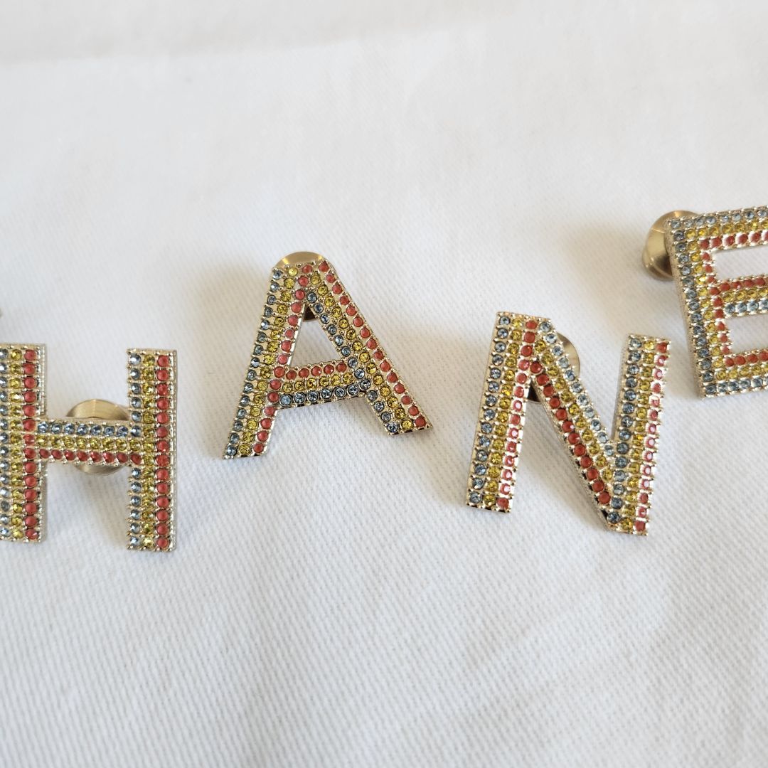 CHANEL crystal embellished Letter brooch