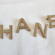 CHANEL crystal embellished Letter brooch