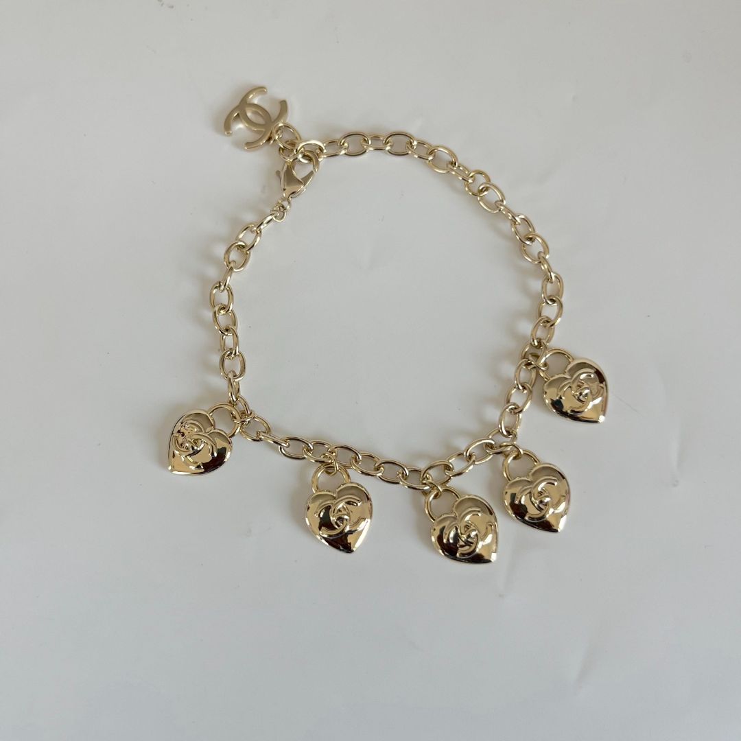 Chanel light gold-tone bracelet with heart charms