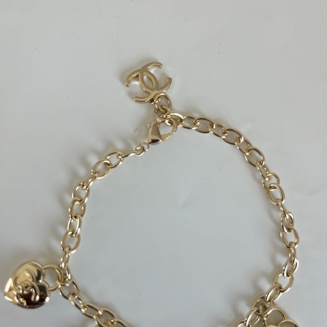 Chanel light gold-tone bracelet with heart charms
