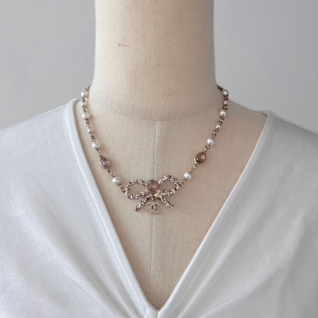 Chanel light gold pearl and pink crystal bow pendant necklace