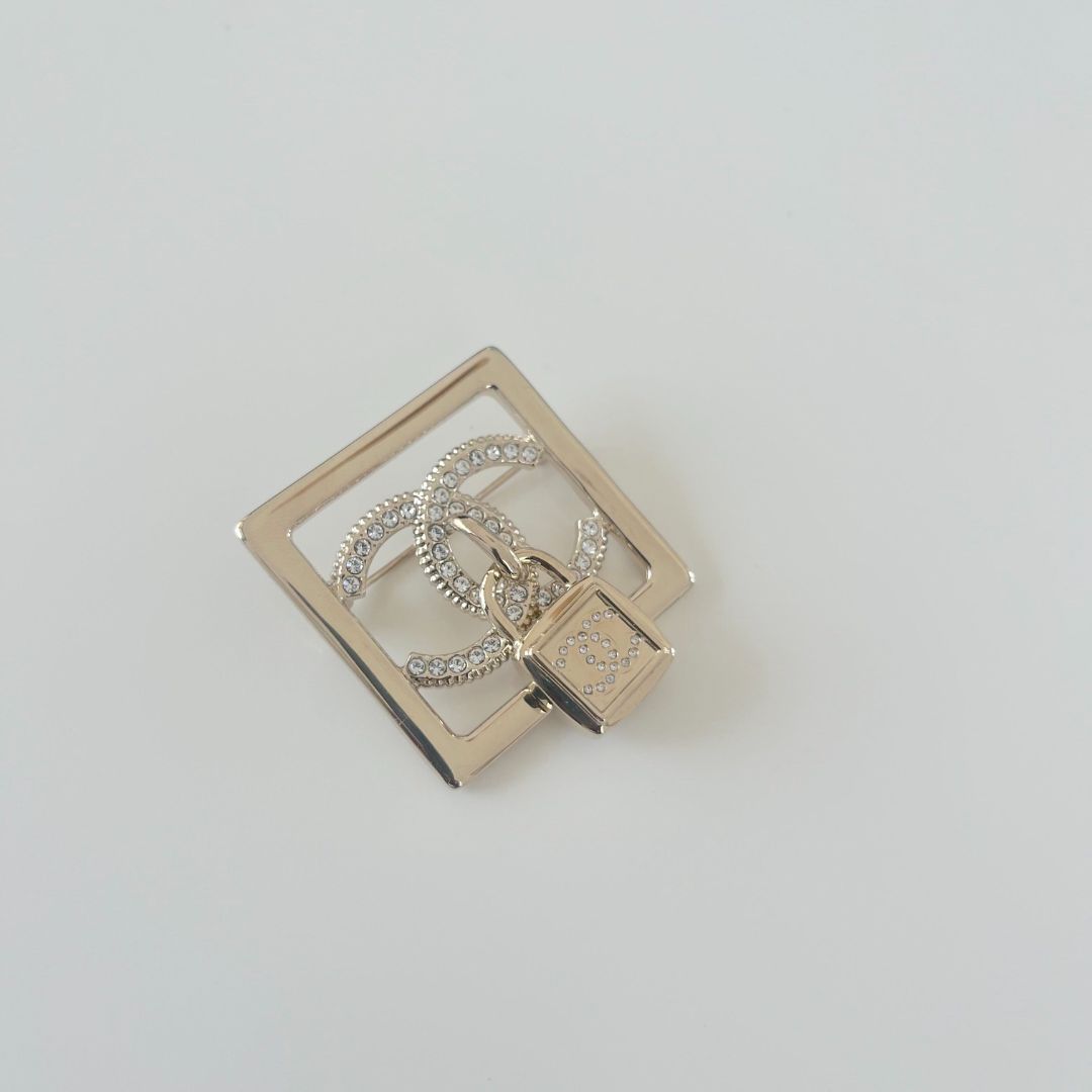 Chanel square gold crystal embellished brooch with lock cc pendant