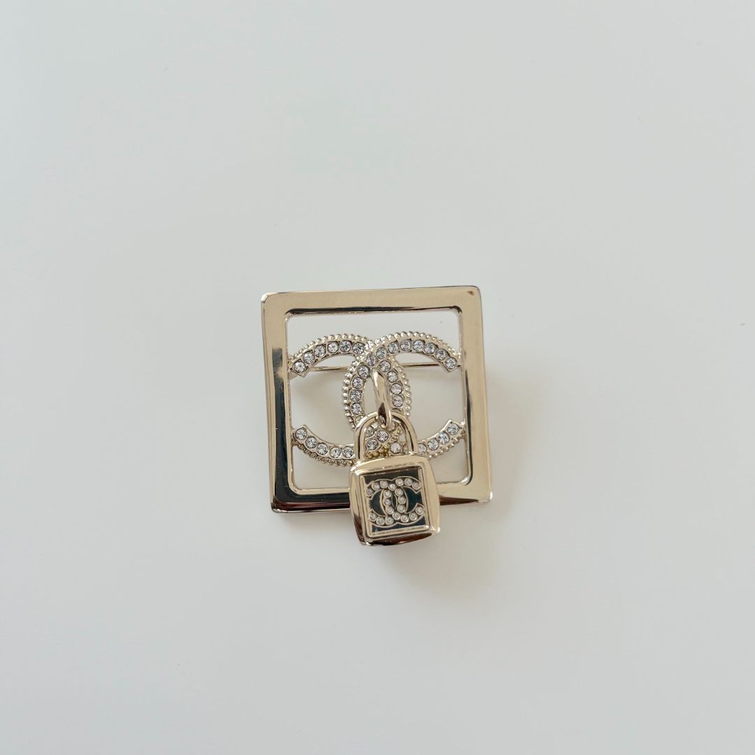 Chanel square gold crystal embellished brooch with lock cc pendant