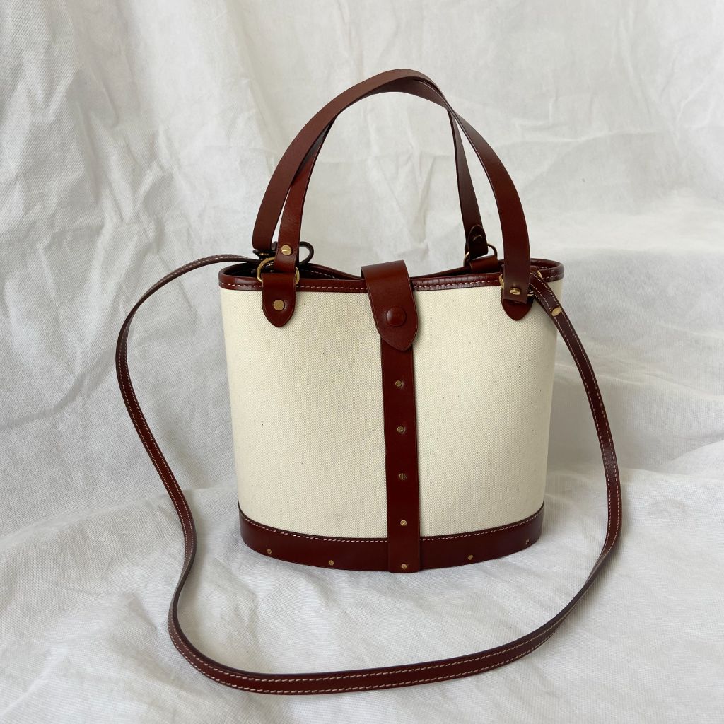 The Row beige canvas and leather bucket bag BOPF Business of